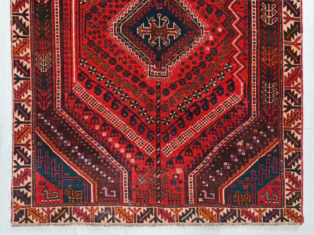 a red rug with a design on it