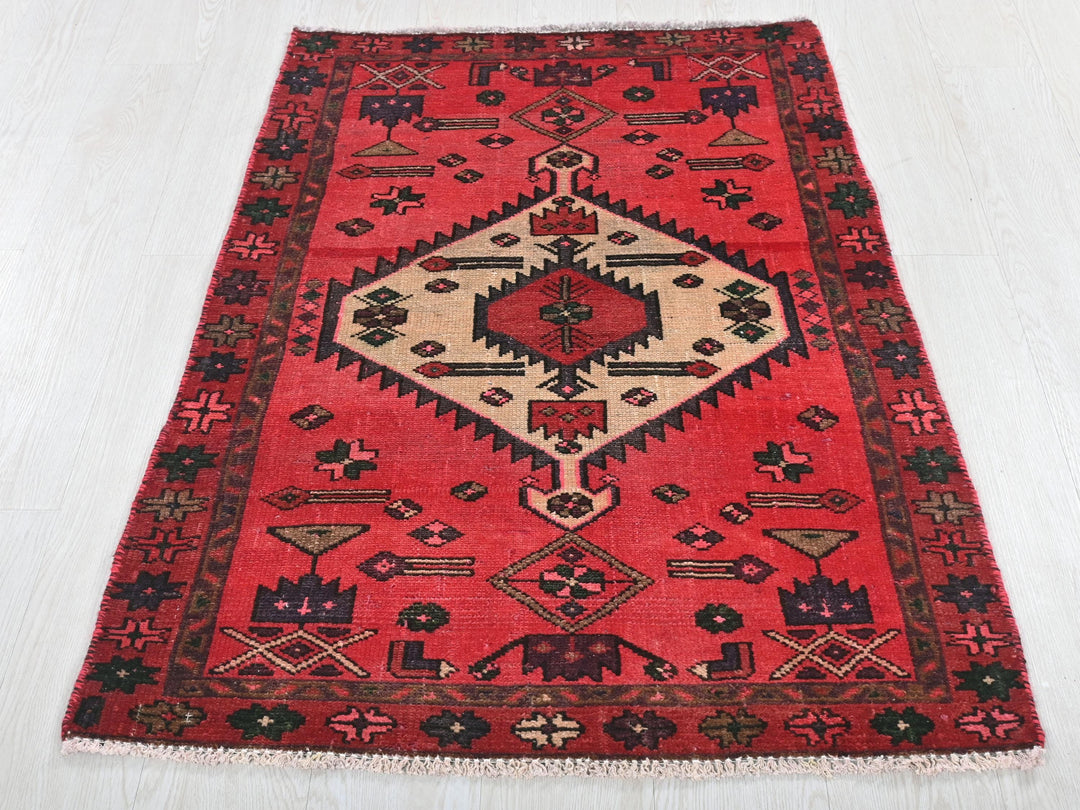 a red rug on a white wooden floor