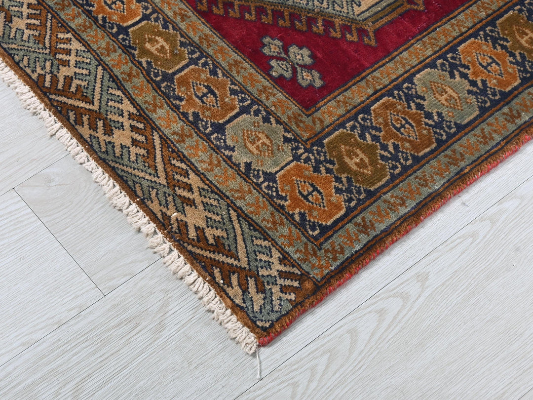 a red and blue rug on a white floor
