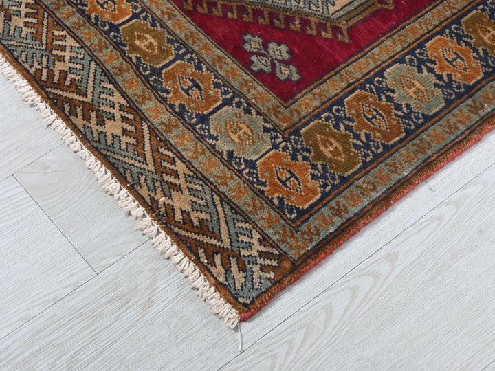 a red and blue rug on a white floor
