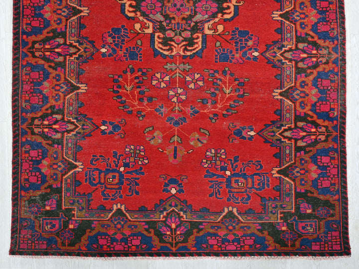 a red rug with a floral design on it