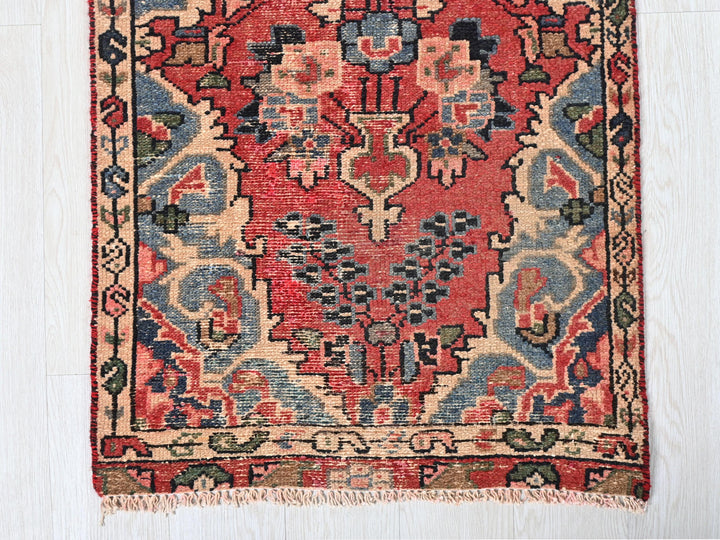 a red and blue oriental rug on a white floor