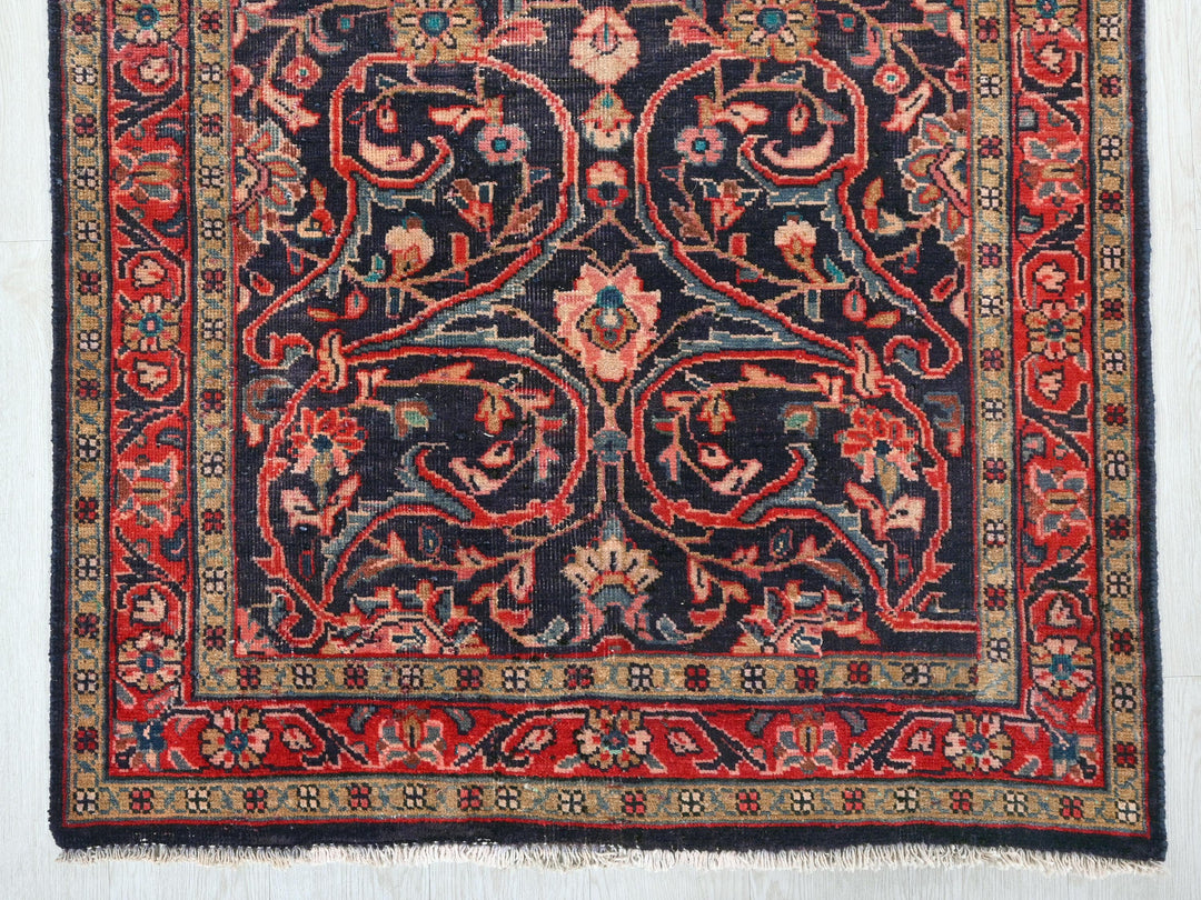 a red and black rug on a white wall
