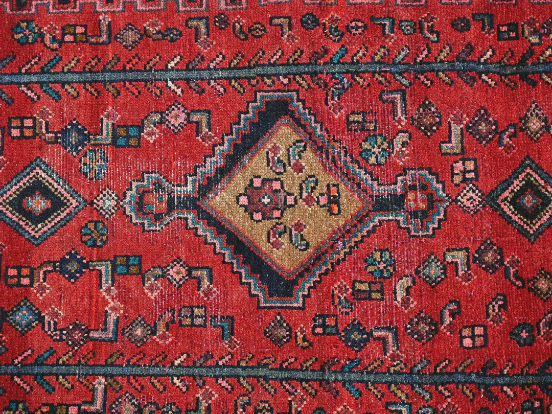 a close up of a red oriental rug