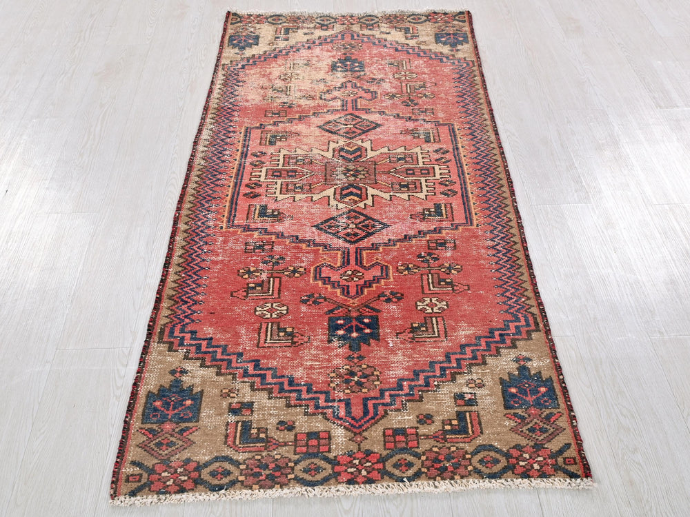 a red rug on a wooden floor with a white floor