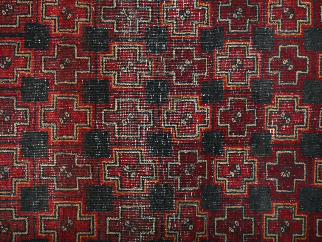 a red and black rug with a pattern on it