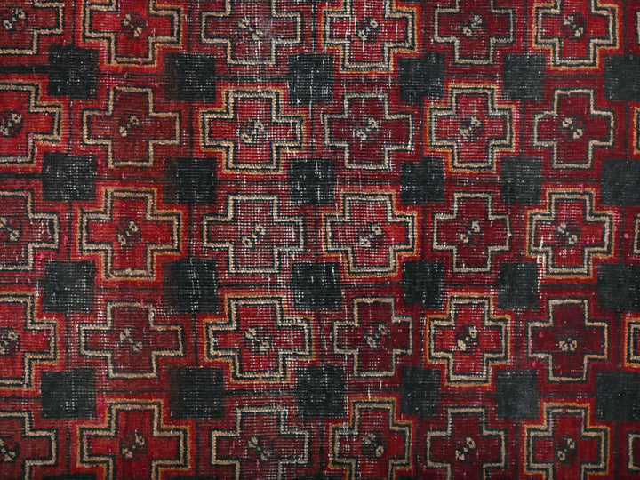a red and black rug with a pattern on it