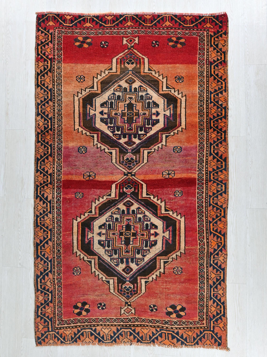 a red rug with a design on it