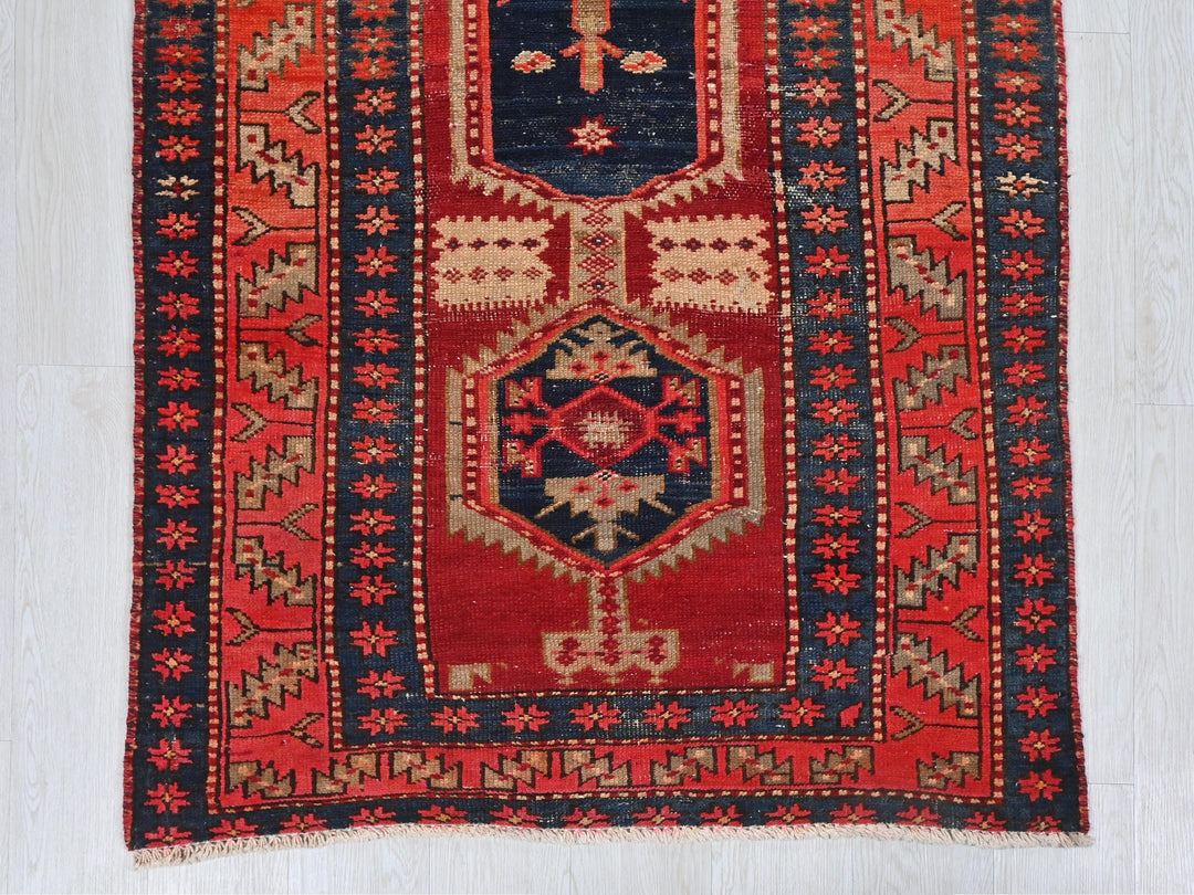 a red and blue oriental rug on a white floor