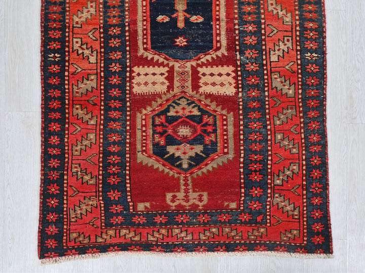 a red and blue oriental rug on a white floor