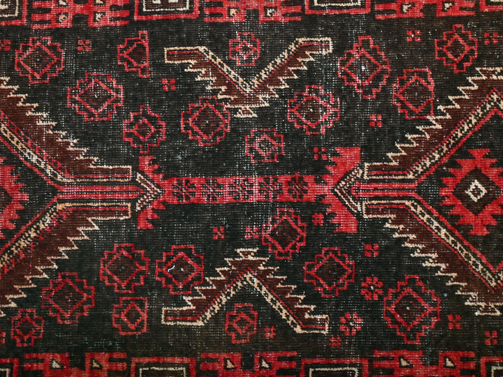 a close up of a red and black rug