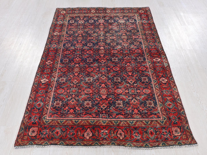 a red and blue rug on a white floor