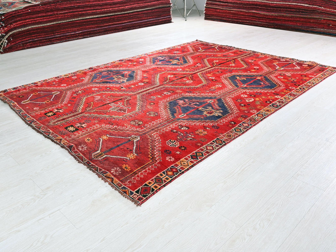 a red rug on the floor of a room
