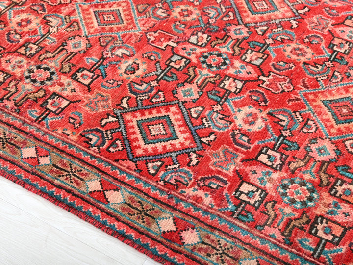 a red oriental rug on a white floor