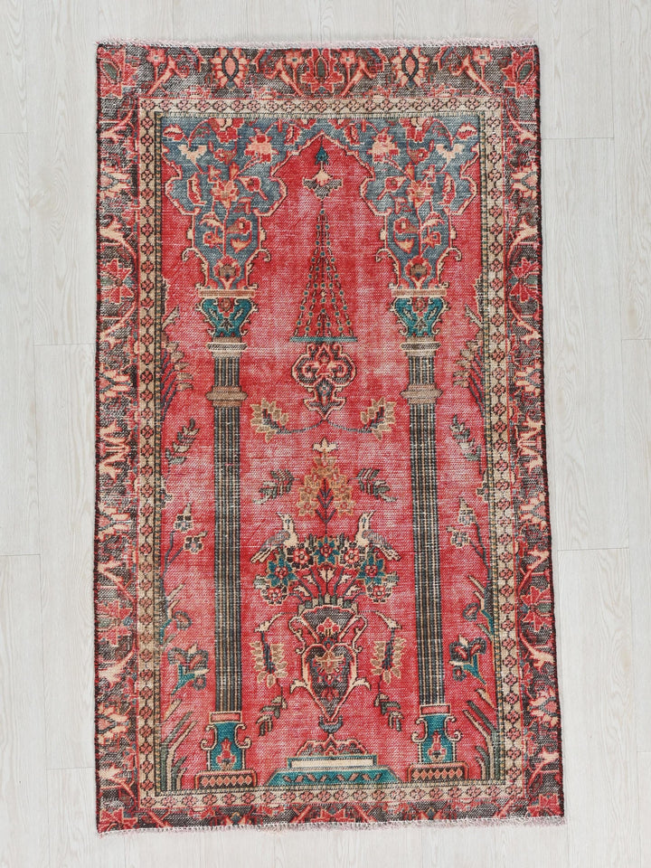 a red rug on a white wooden floor