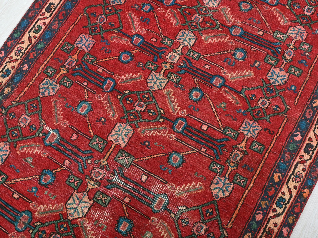 a red rug on a white wooden floor