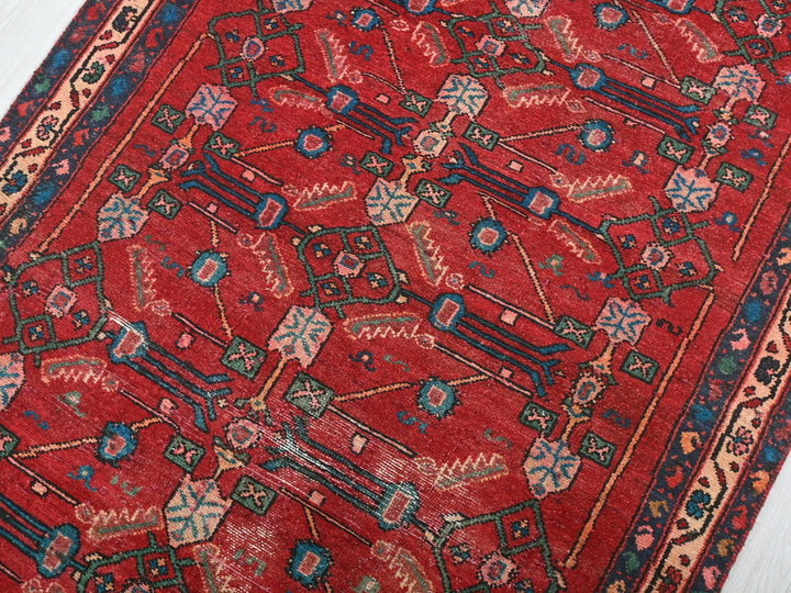 a red rug on a white wooden floor