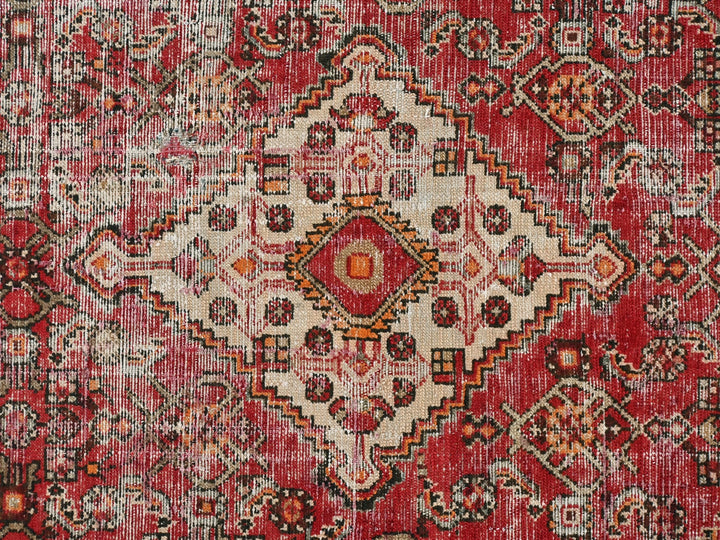 a red rug with an intricate design on it