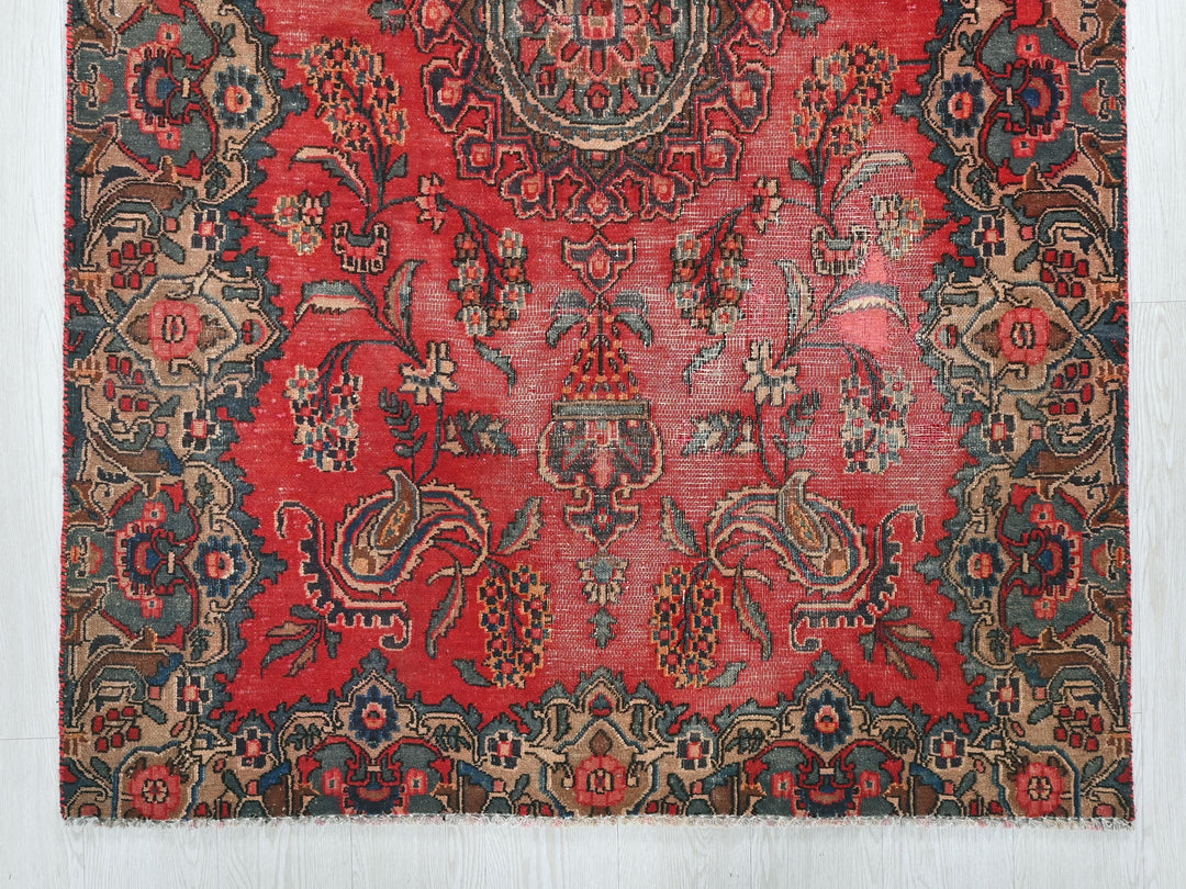 a red and blue rug with an intricate design