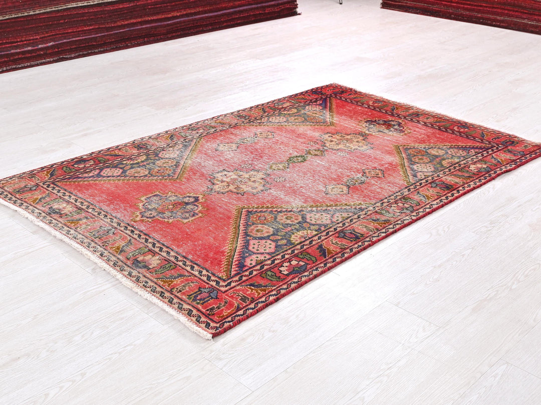 a red rug on the floor of a room