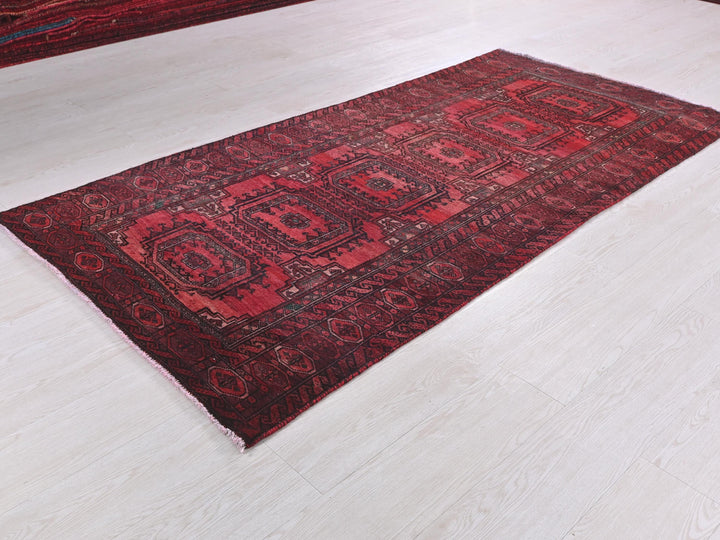 a red rug on the floor of a room