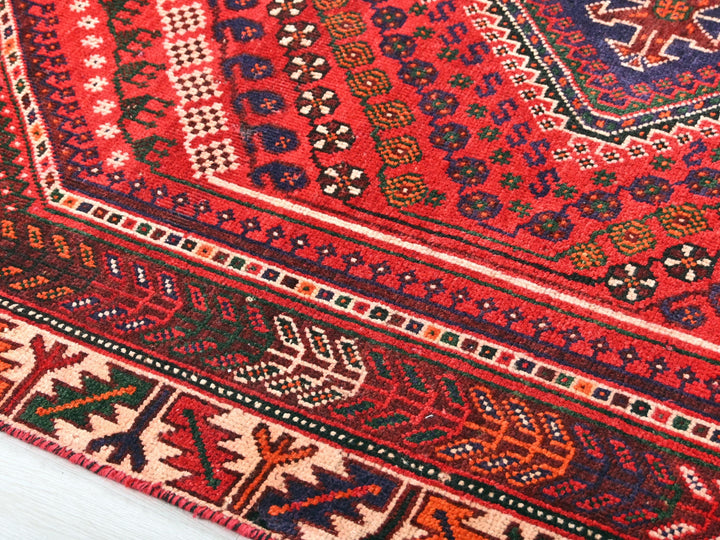 a close up of an oriental rug on a wooden floor