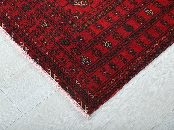a close up of a red rug on the floor