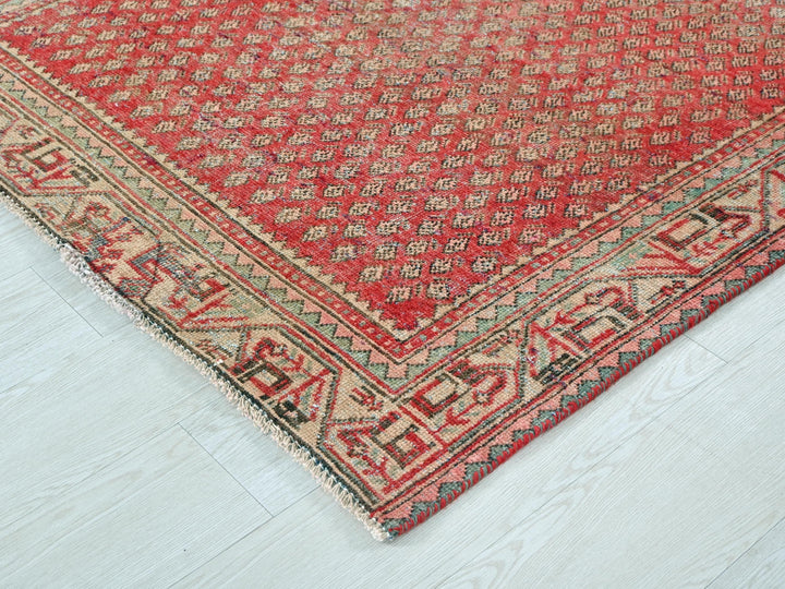 a red rug on a white wooden floor