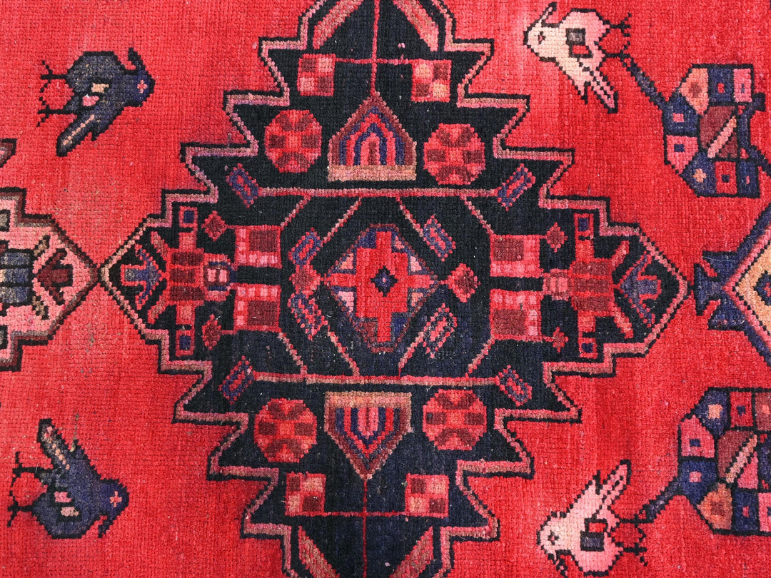a red rug with a design on it