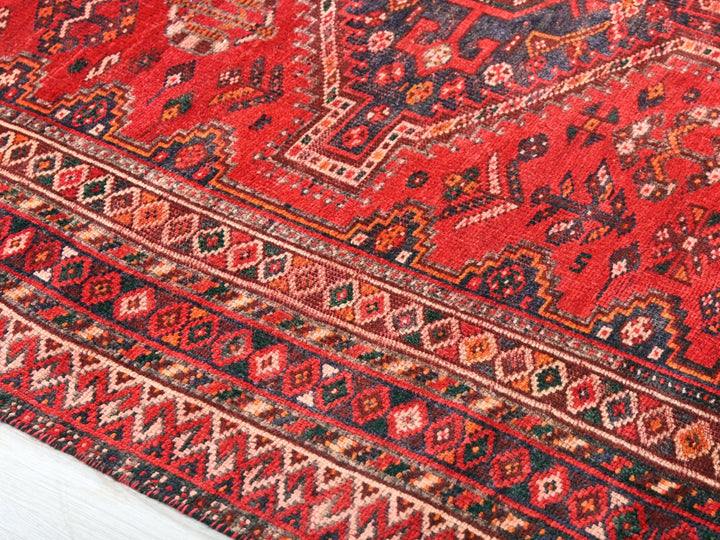 a close up of a red oriental rug