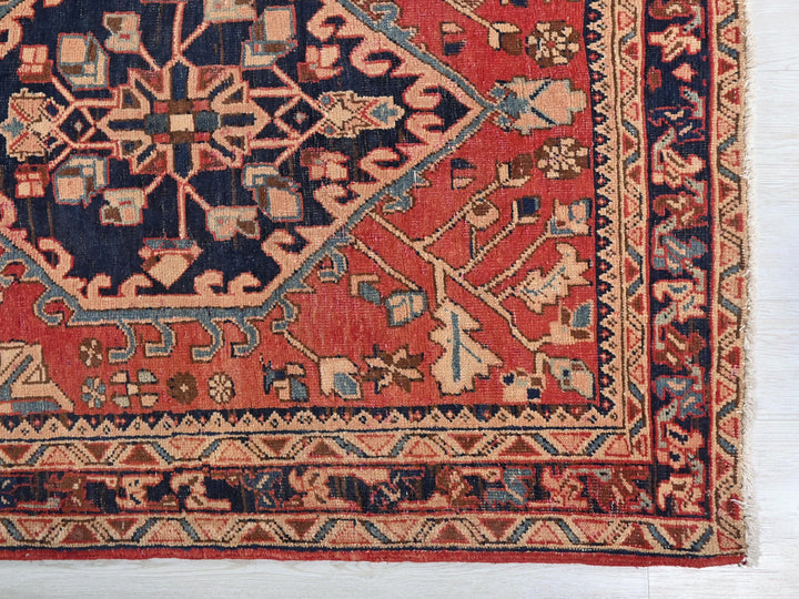 a red rug with a blue design on it