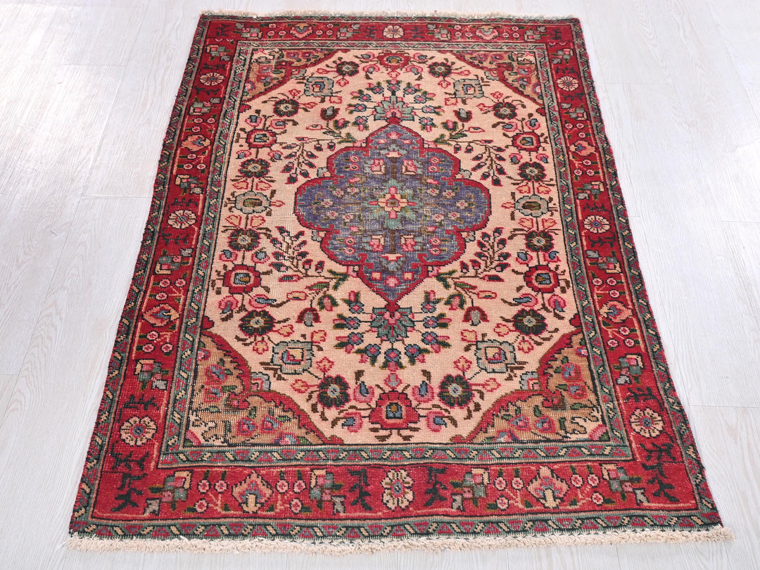a red and blue rug on a white floor