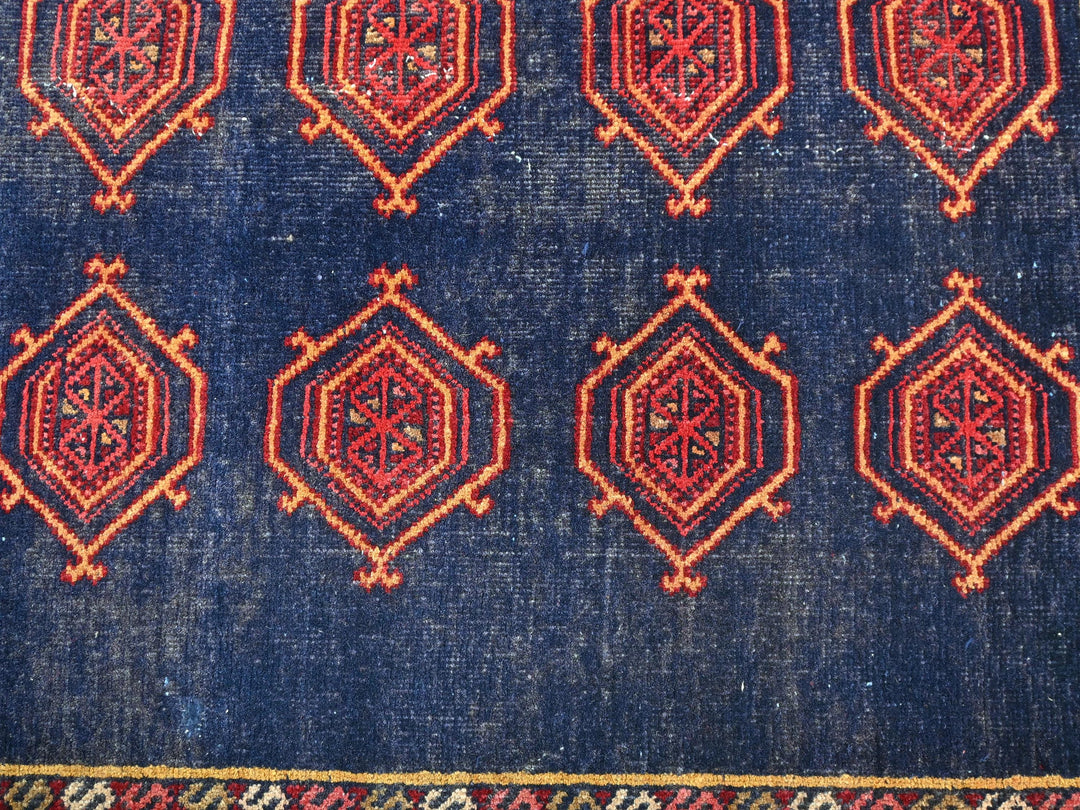 a blue rug with a red design on it