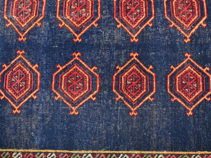 a blue rug with a red design on it