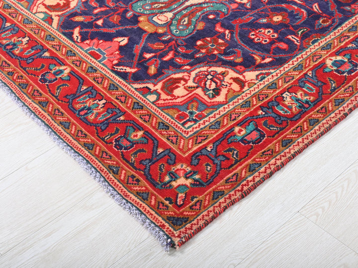 a red and blue rug on a white floor