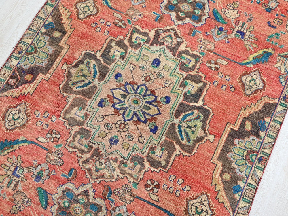a red rug with a floral design on it