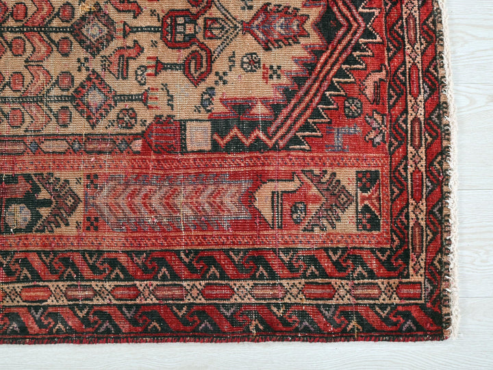 a red and black rug on a white surface