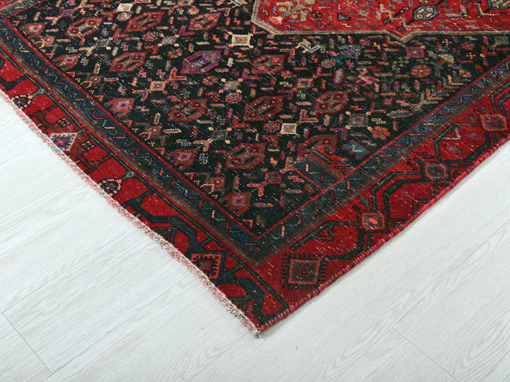 a red and black oriental rug on a white floor