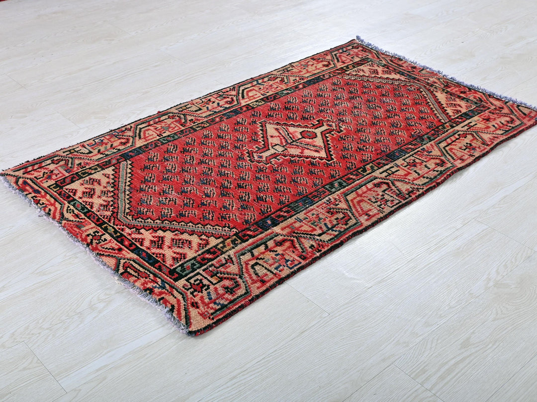 a red rug on a white floor in a room