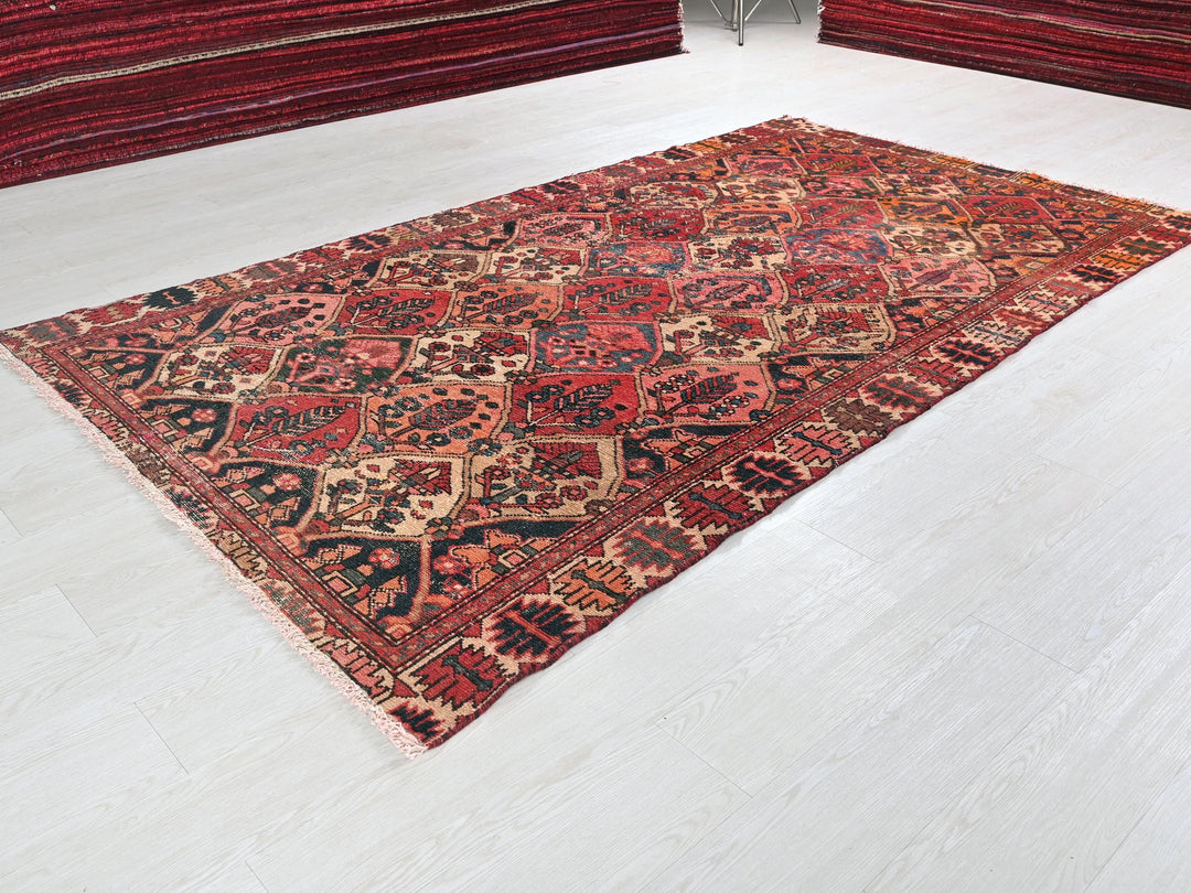 a large red rug on the floor of a room