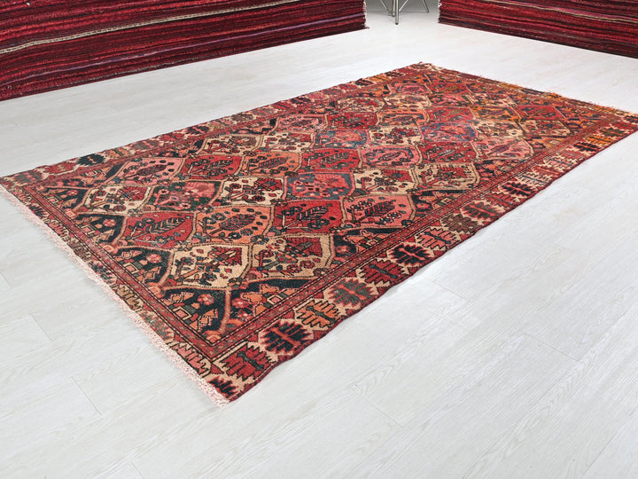 a large red rug on the floor of a room