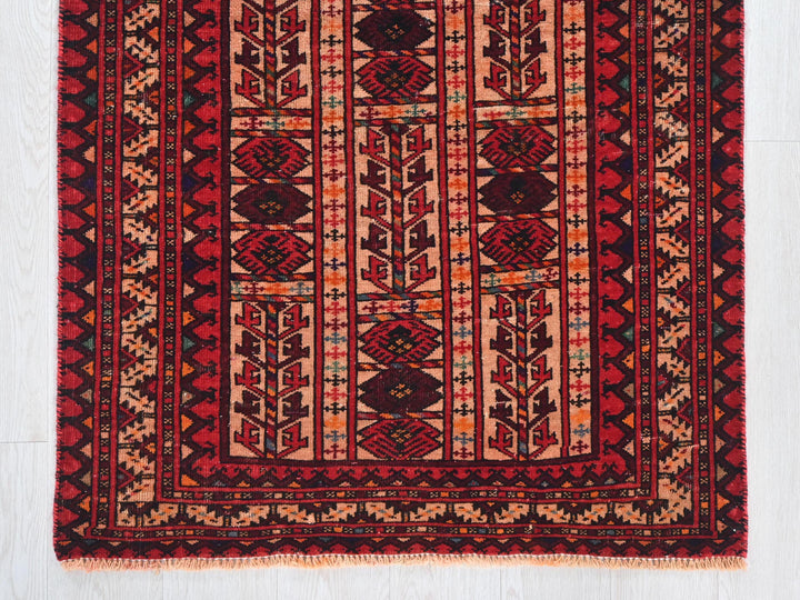 a red and black rug on a white floor