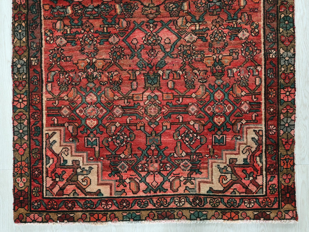 a red rug with an intricate design on it