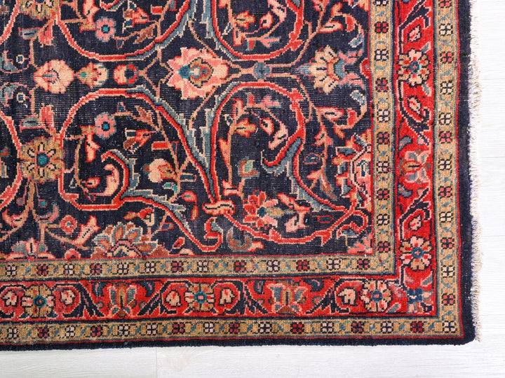 a red and blue rug on a white surface