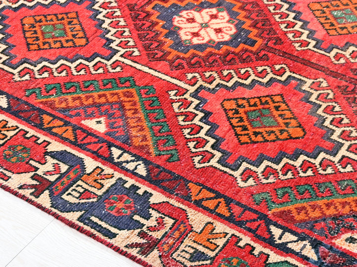 a red rug with a colorful design on it