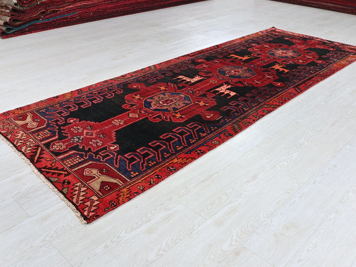 a red and black rug on a white floor