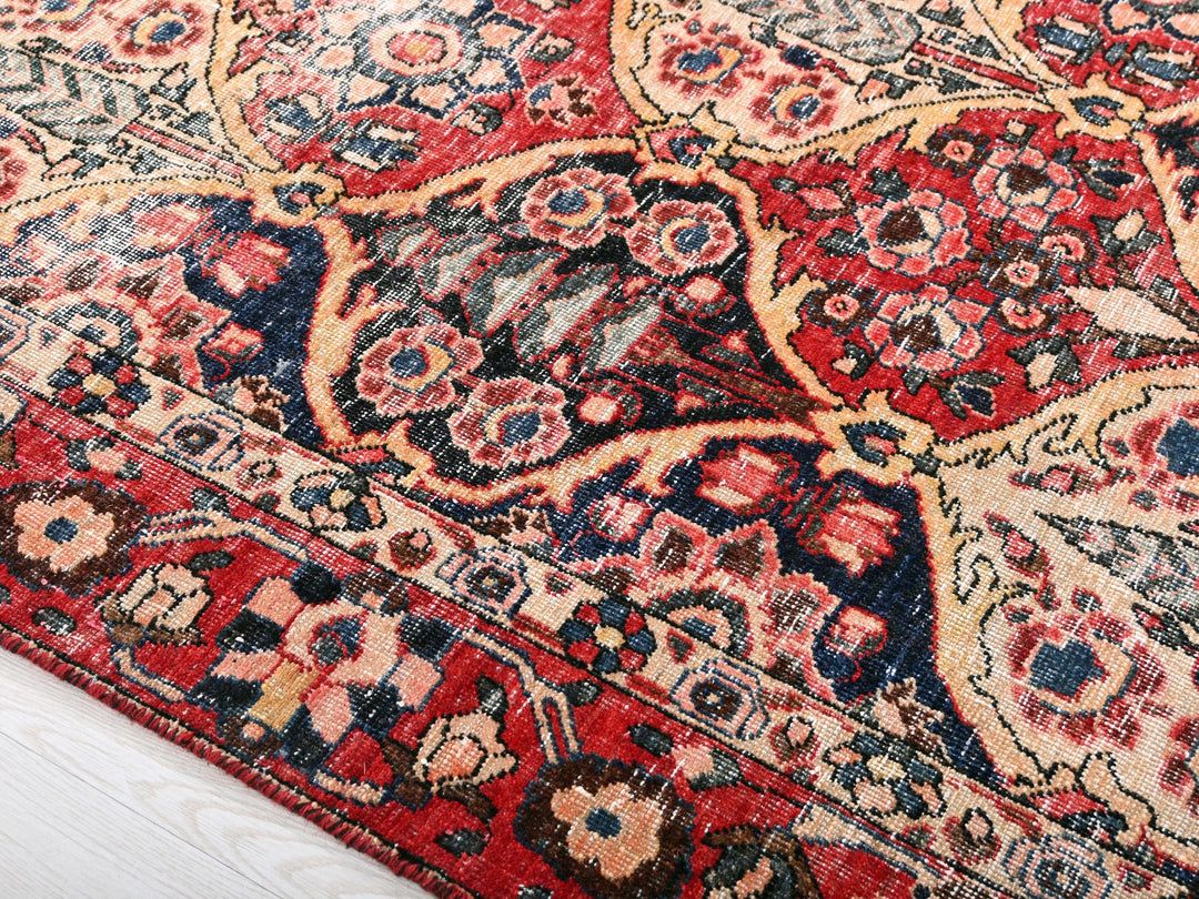 a red and blue oriental rug on a white floor