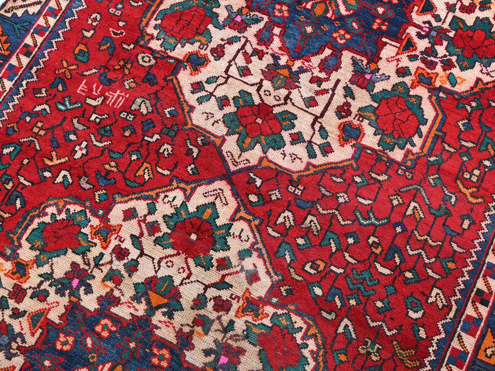 a red and blue rug with many different designs