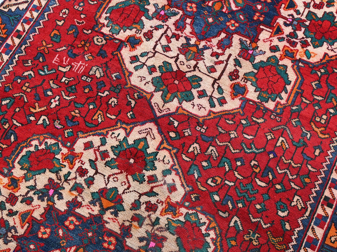 a red and blue rug with many different designs