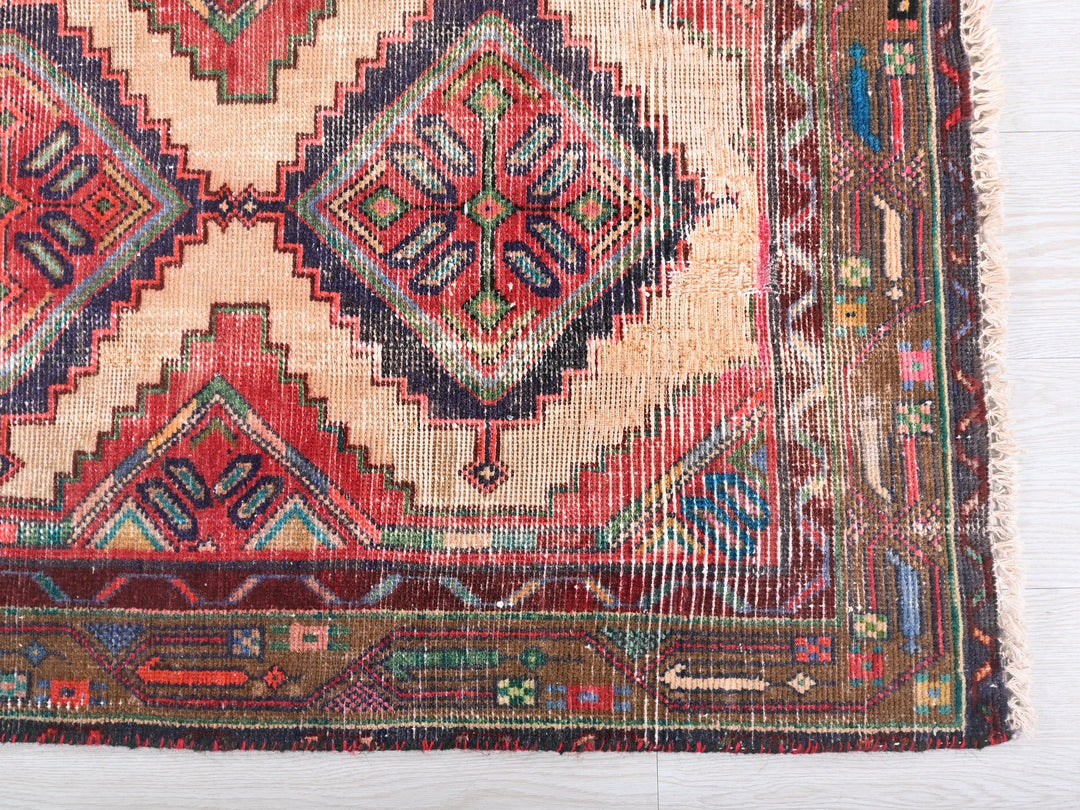 an old rug with a very colorful design on it